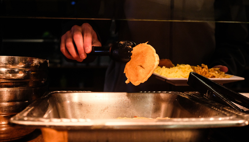 Student selecting a pancake