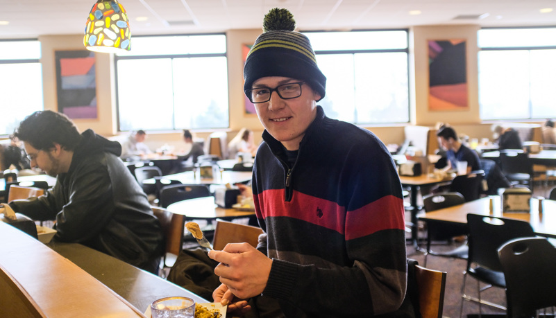 Student selecting a pancake