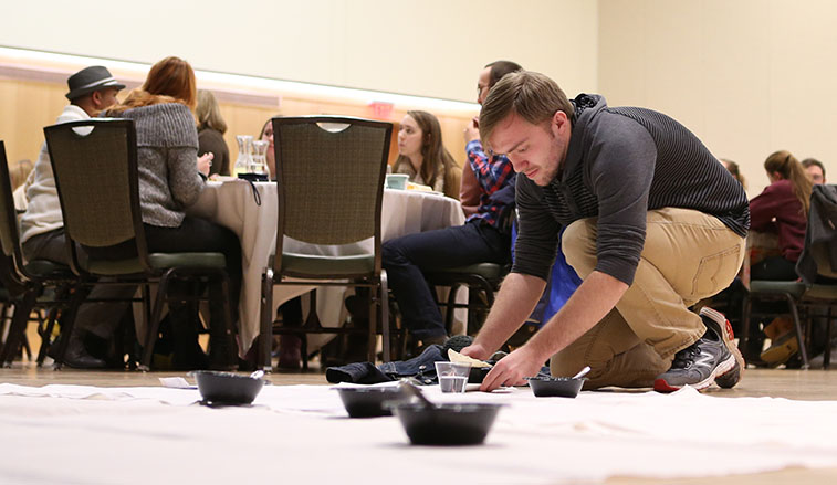 Student participating in the hunger banquet