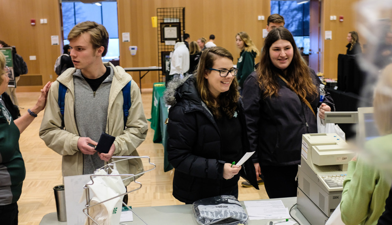 Students paying for caps and gowns