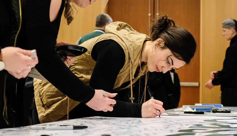 Woman signing a banner