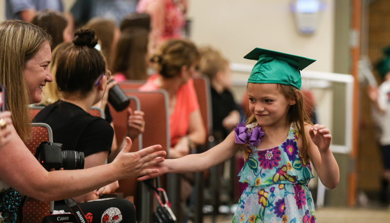 Child giving her parent a high five