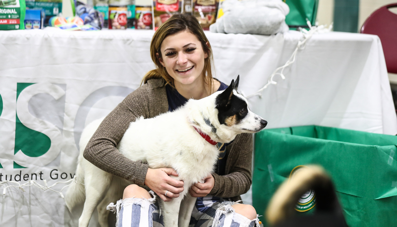 Woman holding a white dog