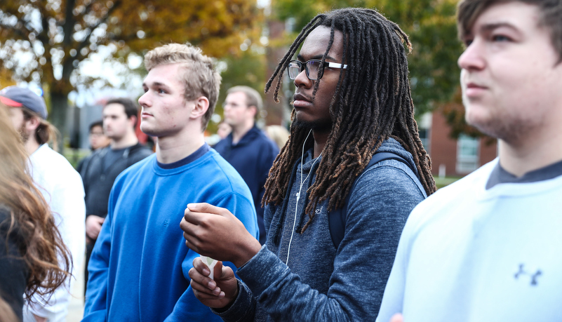 two men during the vigil holding candles