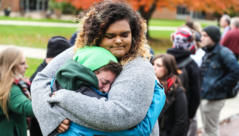 two women hug while crying