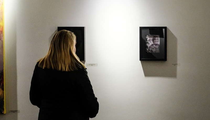 Woman looking at photos on the wall