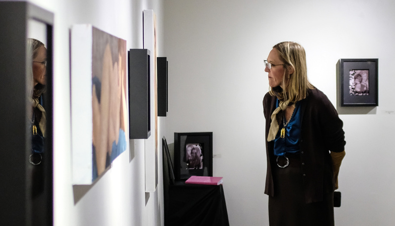 Professor looking at art on the wall