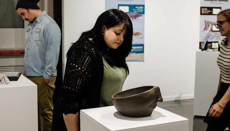 Woman looking at a artistic pot