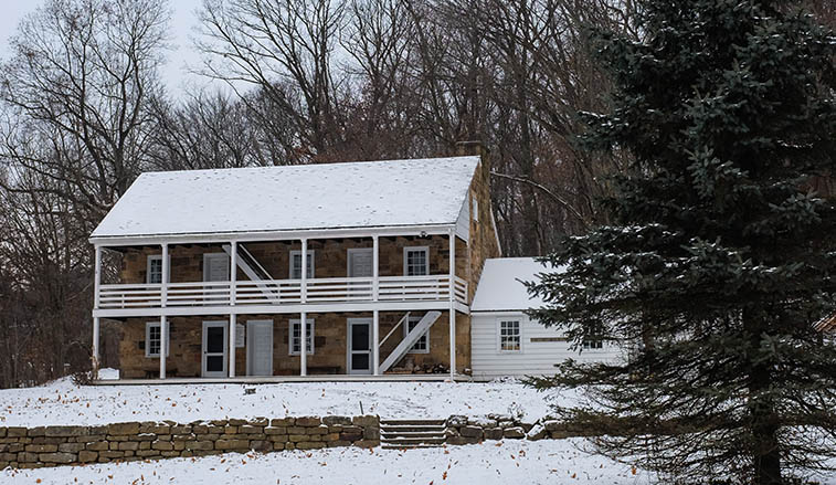 Old Stone House covered in snow