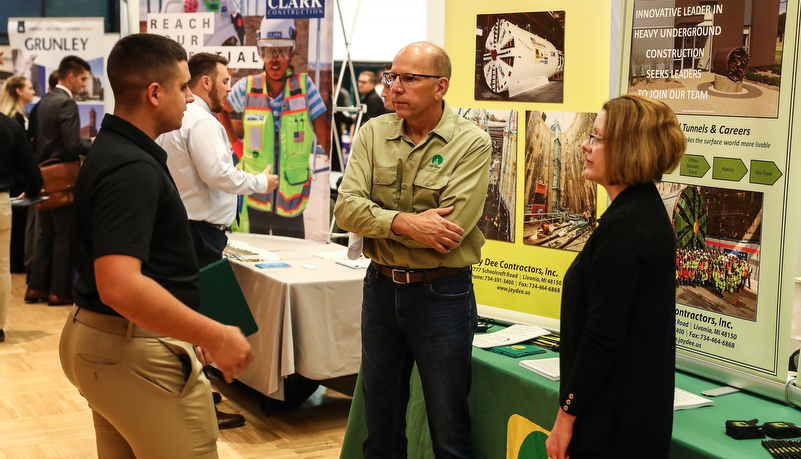 students talking to employers