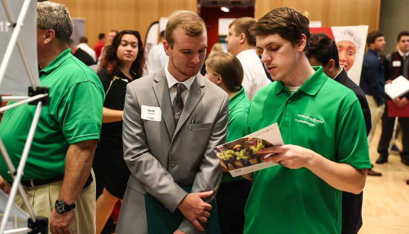 students talking to employers