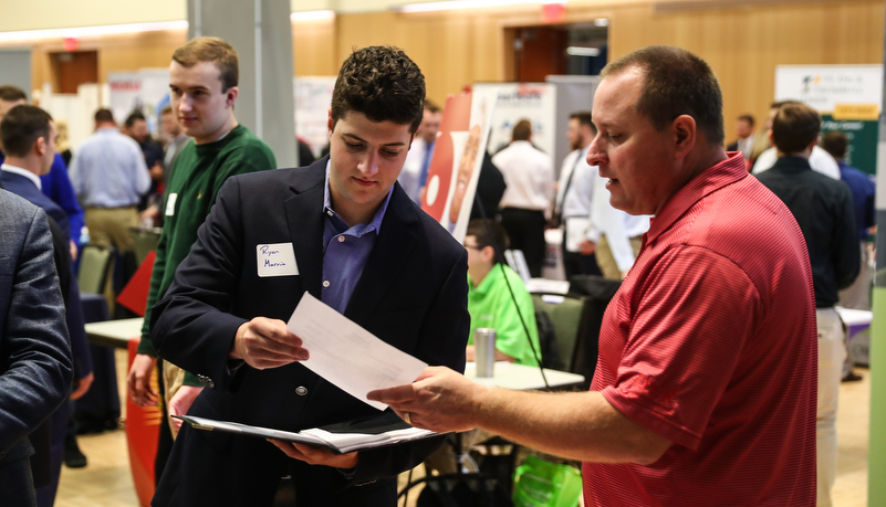 students talking to employers