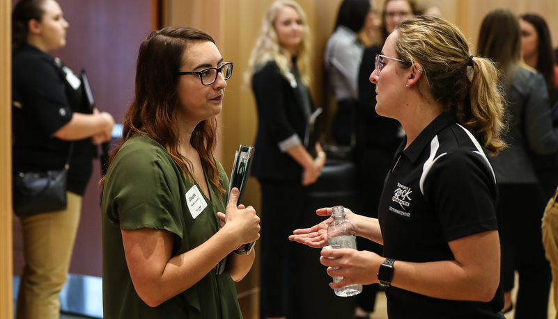 students talking to employers