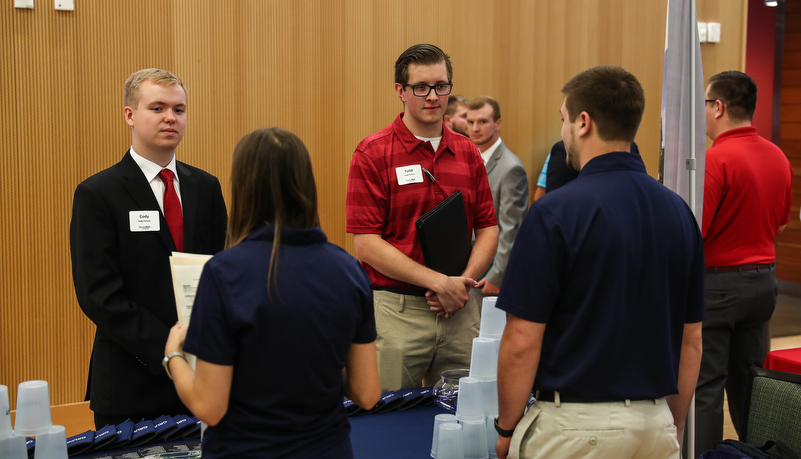 students talking to employers