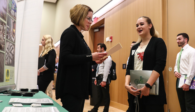 students talking to employers