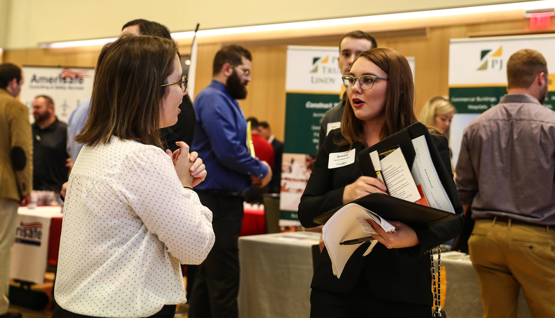 students talking to employers