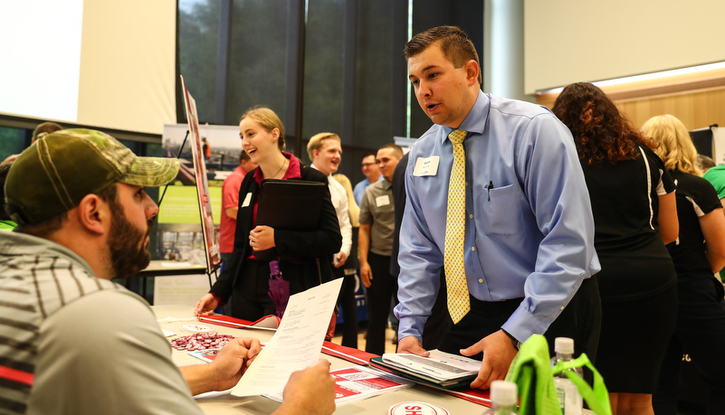 students talking to employers