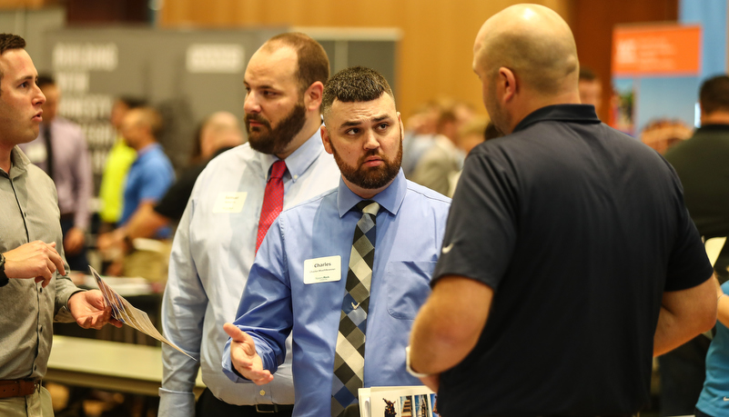 students talking to employers