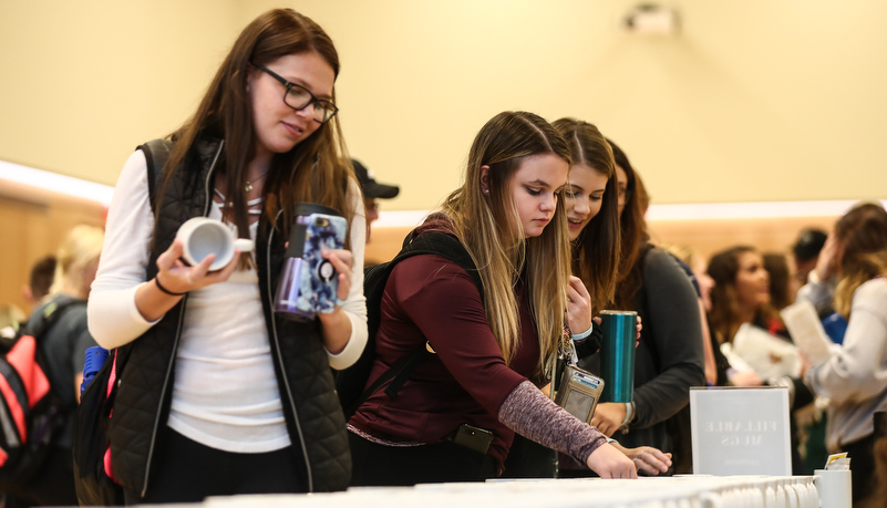 Students selecting a mug