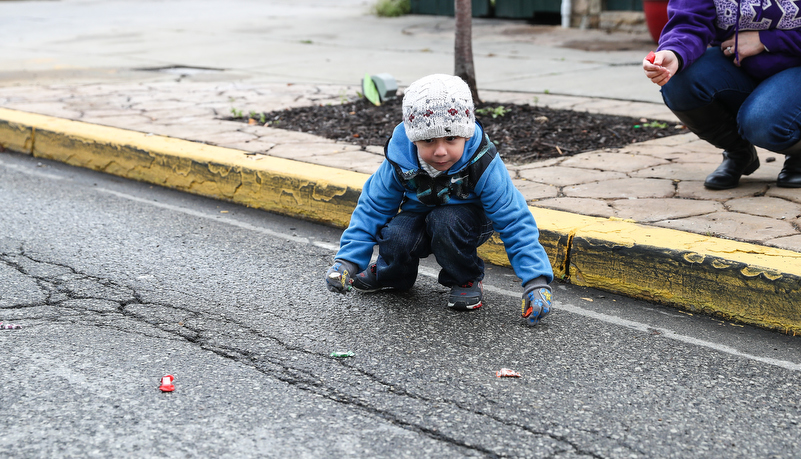 boy picking up candy