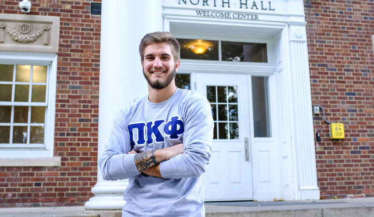 Student standing on the steps of North Hall