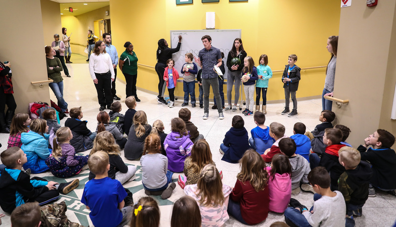 Second graders listen to a presentation