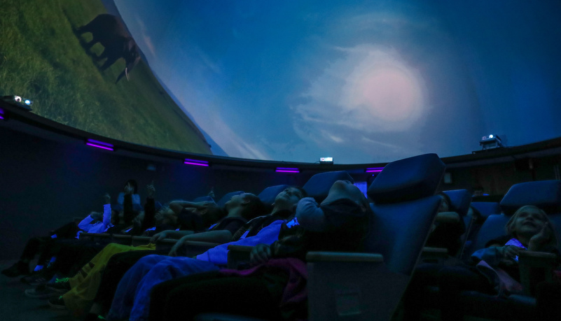 Second graders watch a show in the planetarium