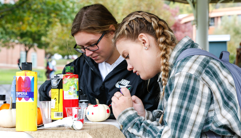 Students painting pumpkins