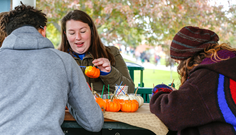 Students painting pumpkins