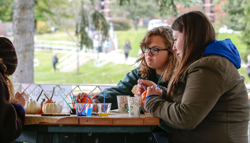 Students painting pumpkins