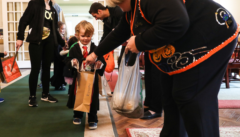 Boy dressed like Harry Potter getting candy