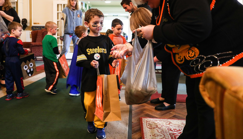 Boy dressed like a Pittsburgh Steeler getting candy