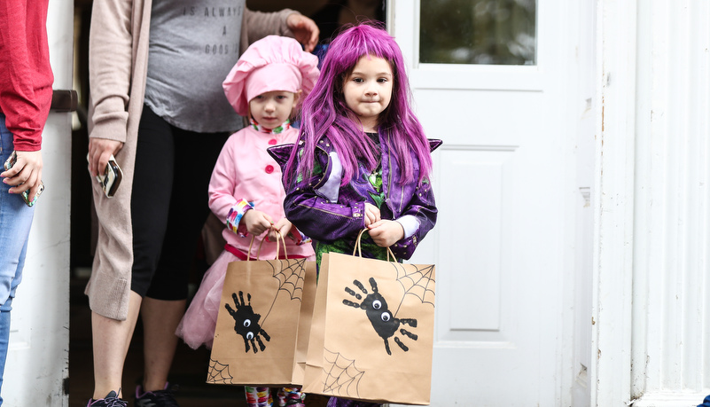 Girl in a costume getting candy