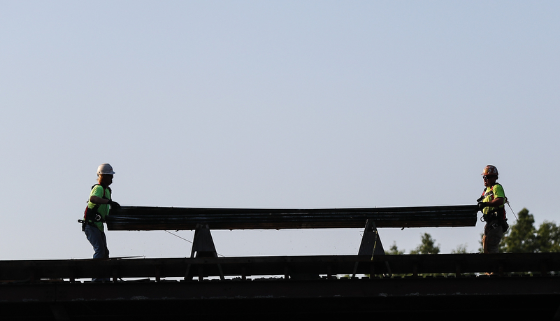 Workers on the roof on Miller auditorium