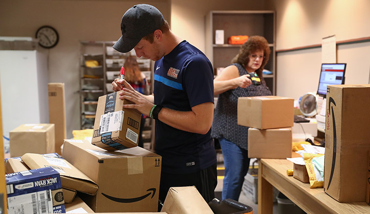 Mail room staff processing incoming packages