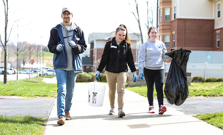 Students picking up trash on campus