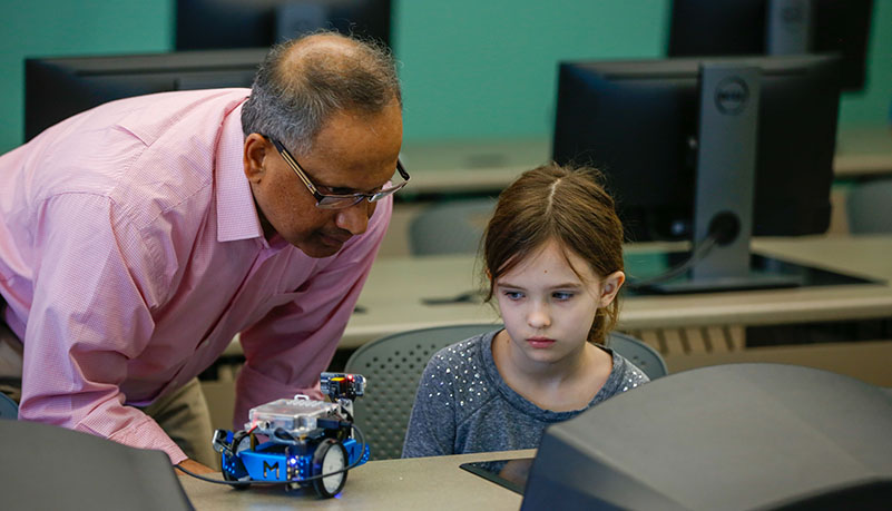 Old teacher helping child