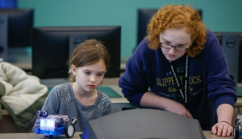 teacher helping child learn