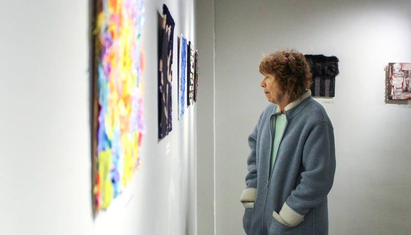 a woman looking at art