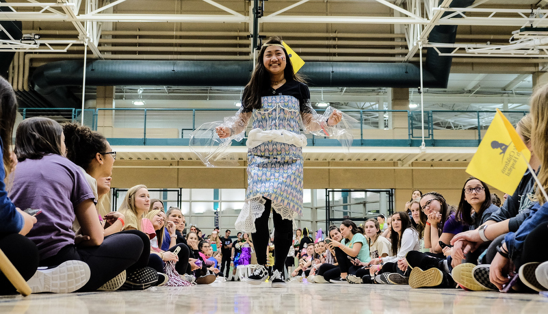 students participat in a trash fashion show