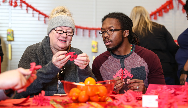 two students making Chinese crafts