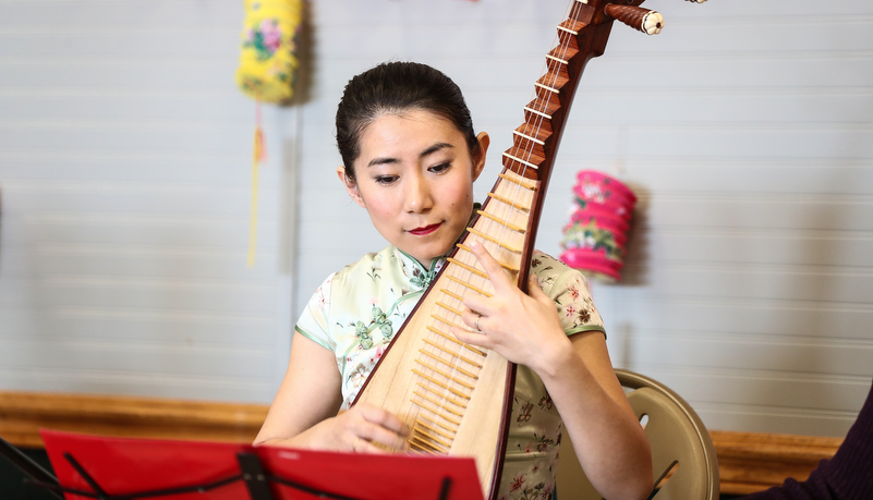 Woman playing traditional instrument