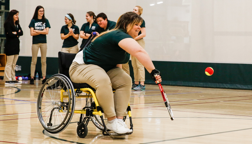 Woman playing tennis in a wheelchair