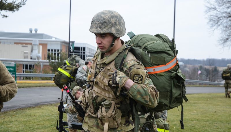 Cadet putting on a ruck sack