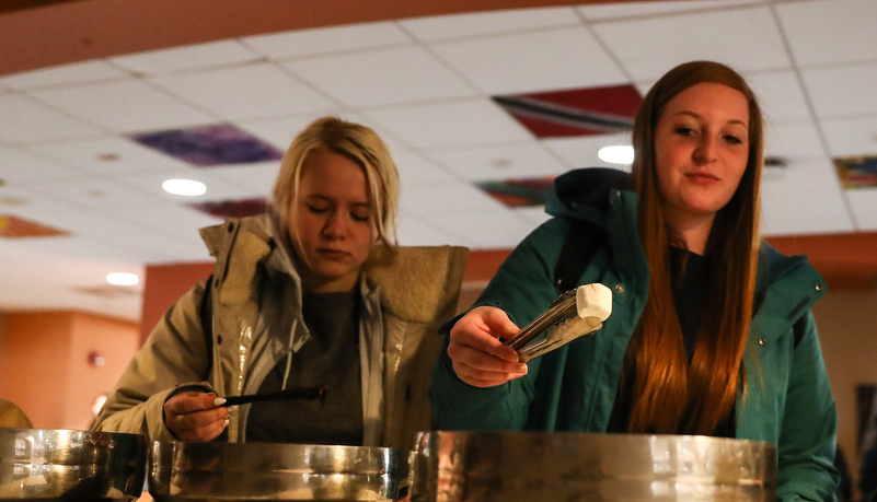 Woman selecting a marshmallow for her smore