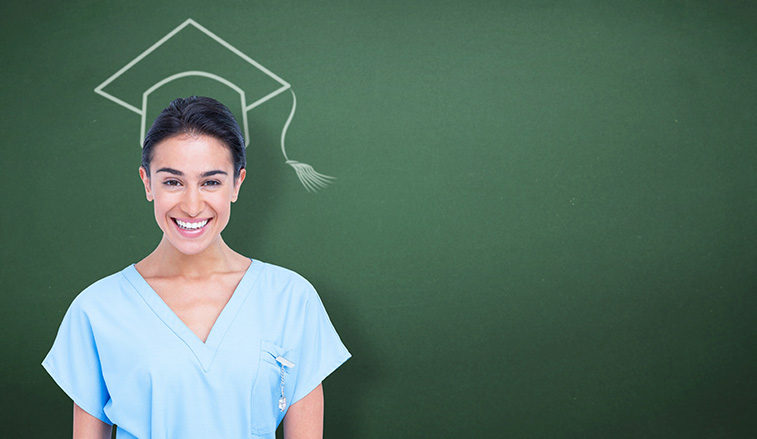 Nurse standing in front of a chalk drawing of a graduation cap