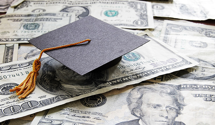 Small graduation cap on money