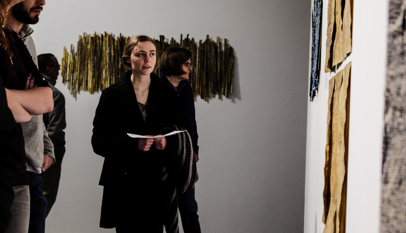 Woman looking at art on display