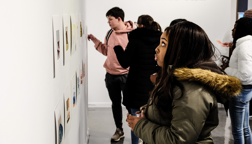 a woman looking at art on display