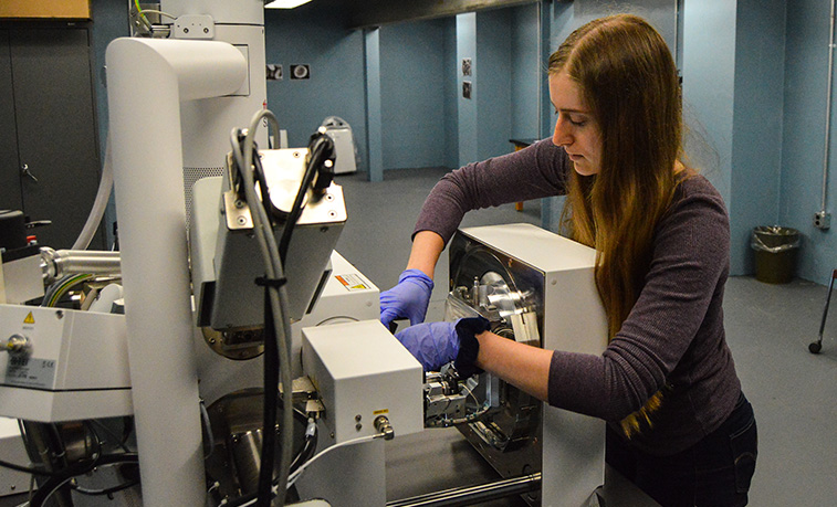 Student working on an electron microscope